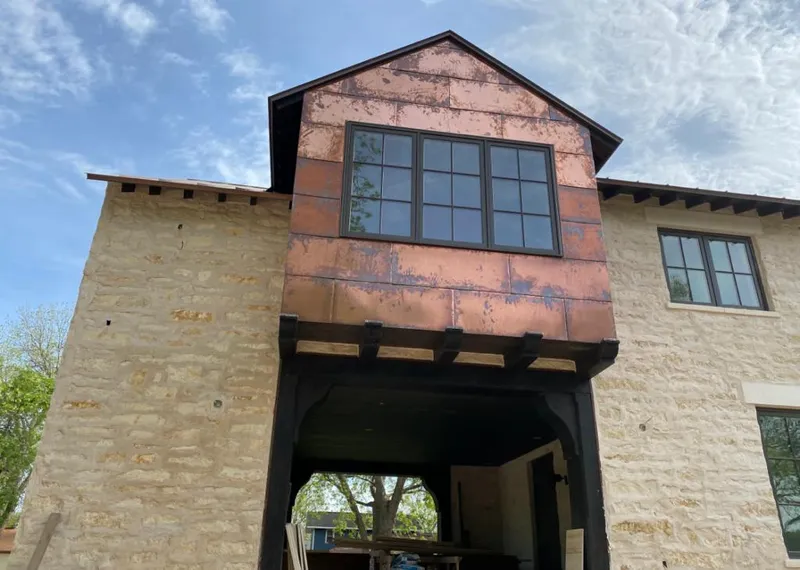 Copper metal panel facade on a stone building for Skylight Installation in Carterville